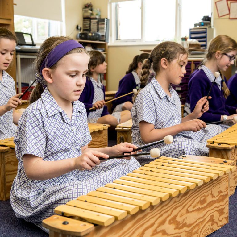 school girls playing instruments
