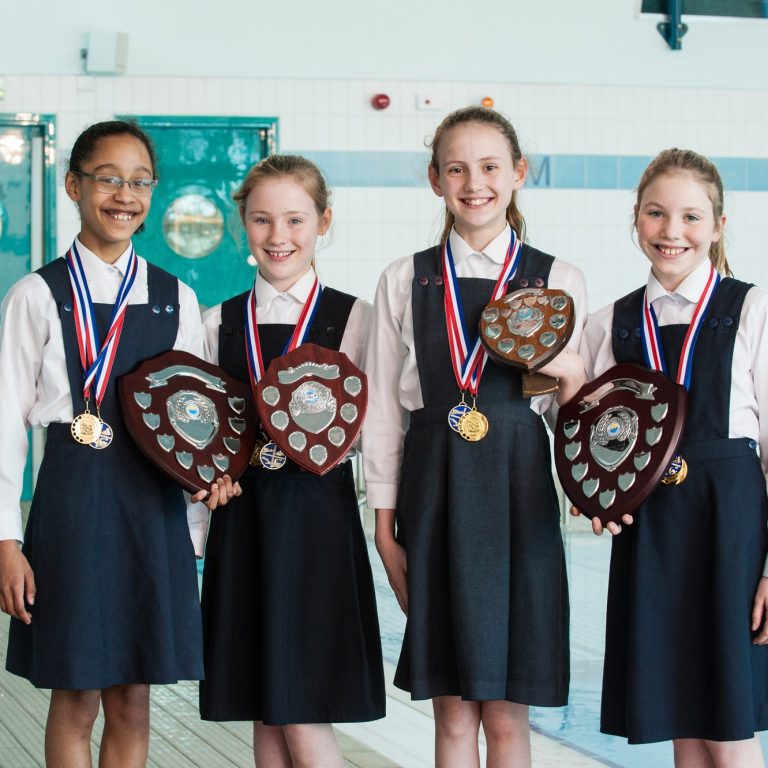 4 girls holding awards