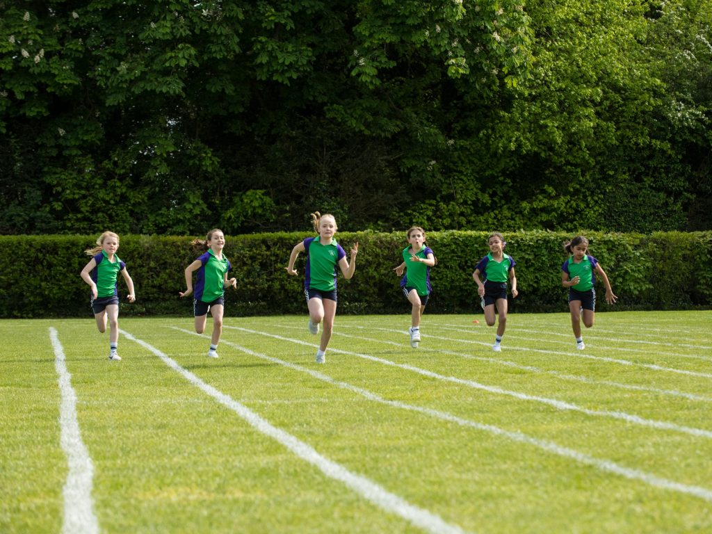 girls running across the pitch
