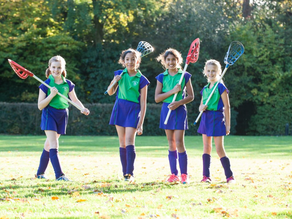 Girls holding lacrosse batons