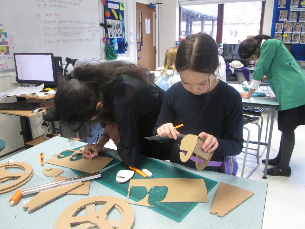 girls working with wood and cardboard