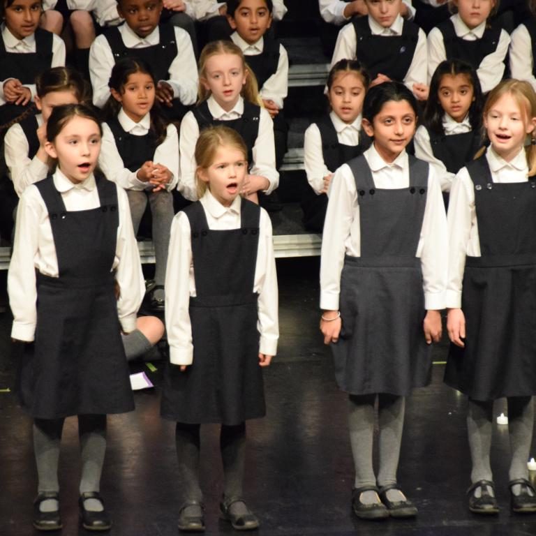 4 students singing at the front