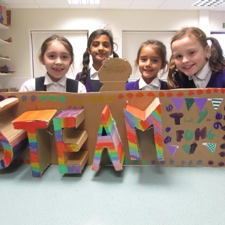 STEAM in a cardboard cutout and rainbow paint