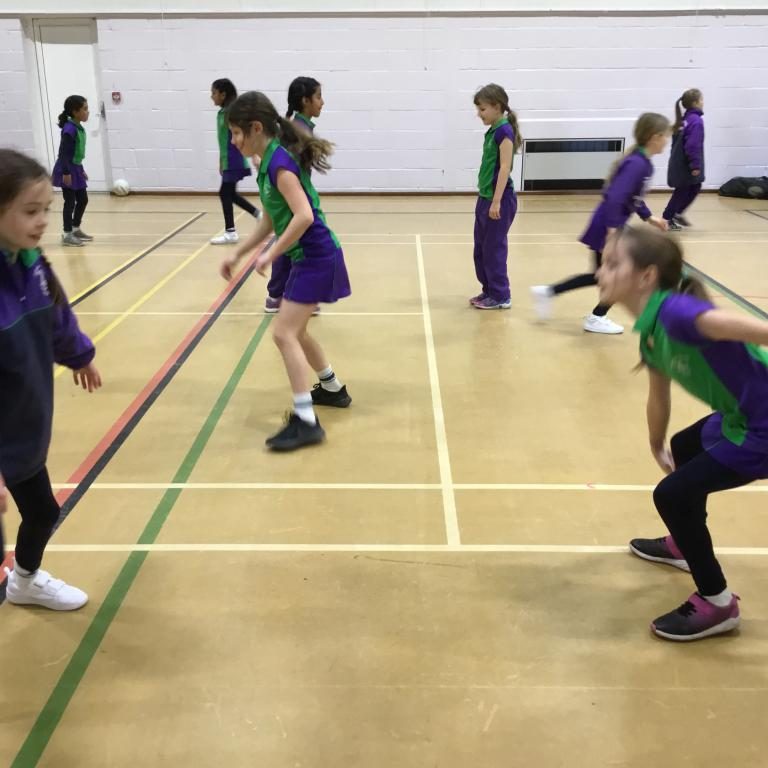Students practicing the skills learnt from netball