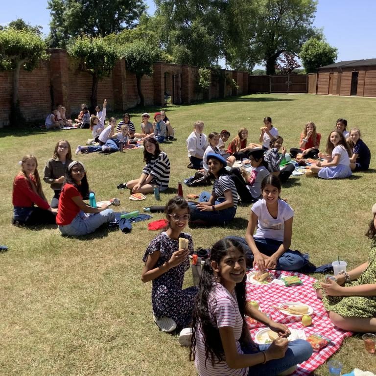 Students eating a picnic in the sun