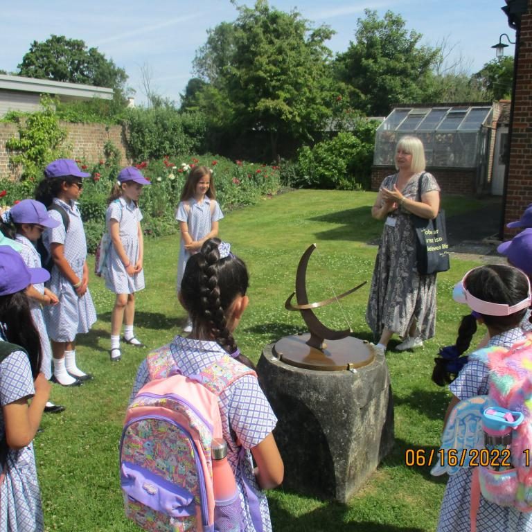 The teacher talks to the class about a sundial they are looking at