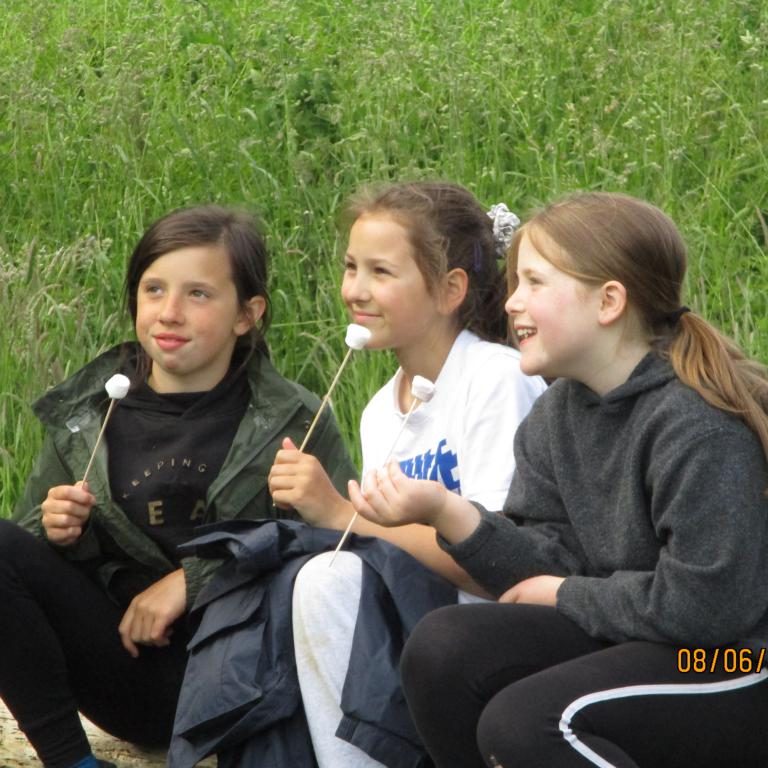 3 students eating marshmallows