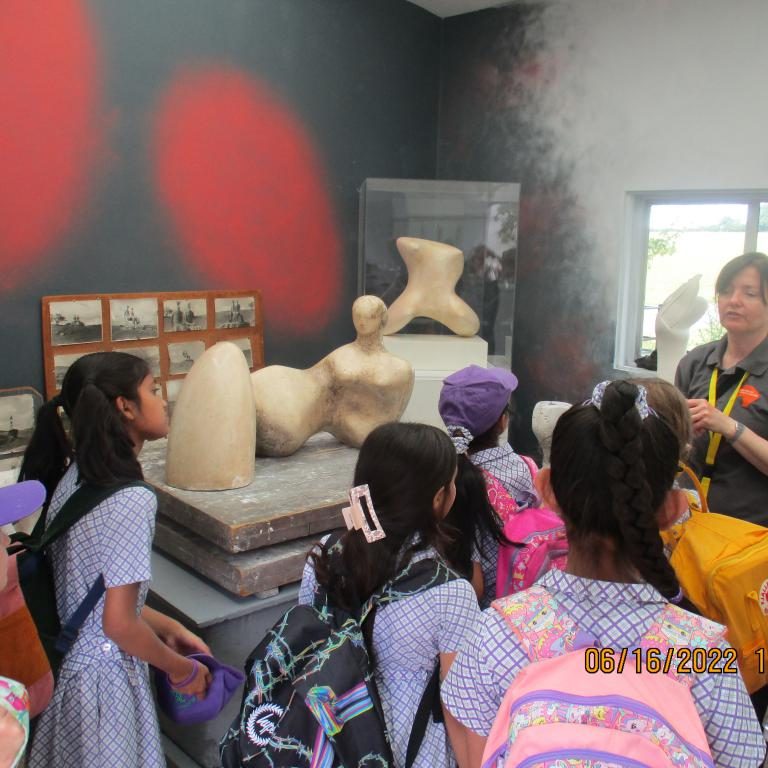 Students looking at sculptures
